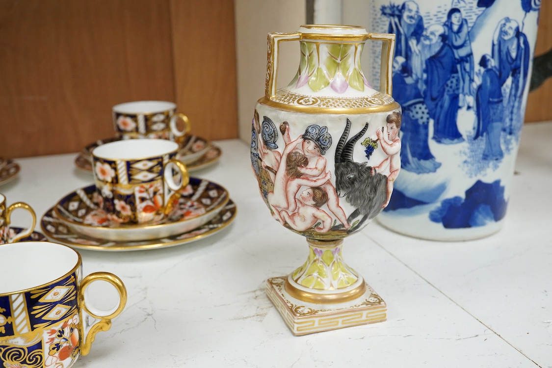 A Crown Derby Imari seven trio place setting, three other cups and two saucers, a large plate and a pair of Doccia- style vases, 18cm high